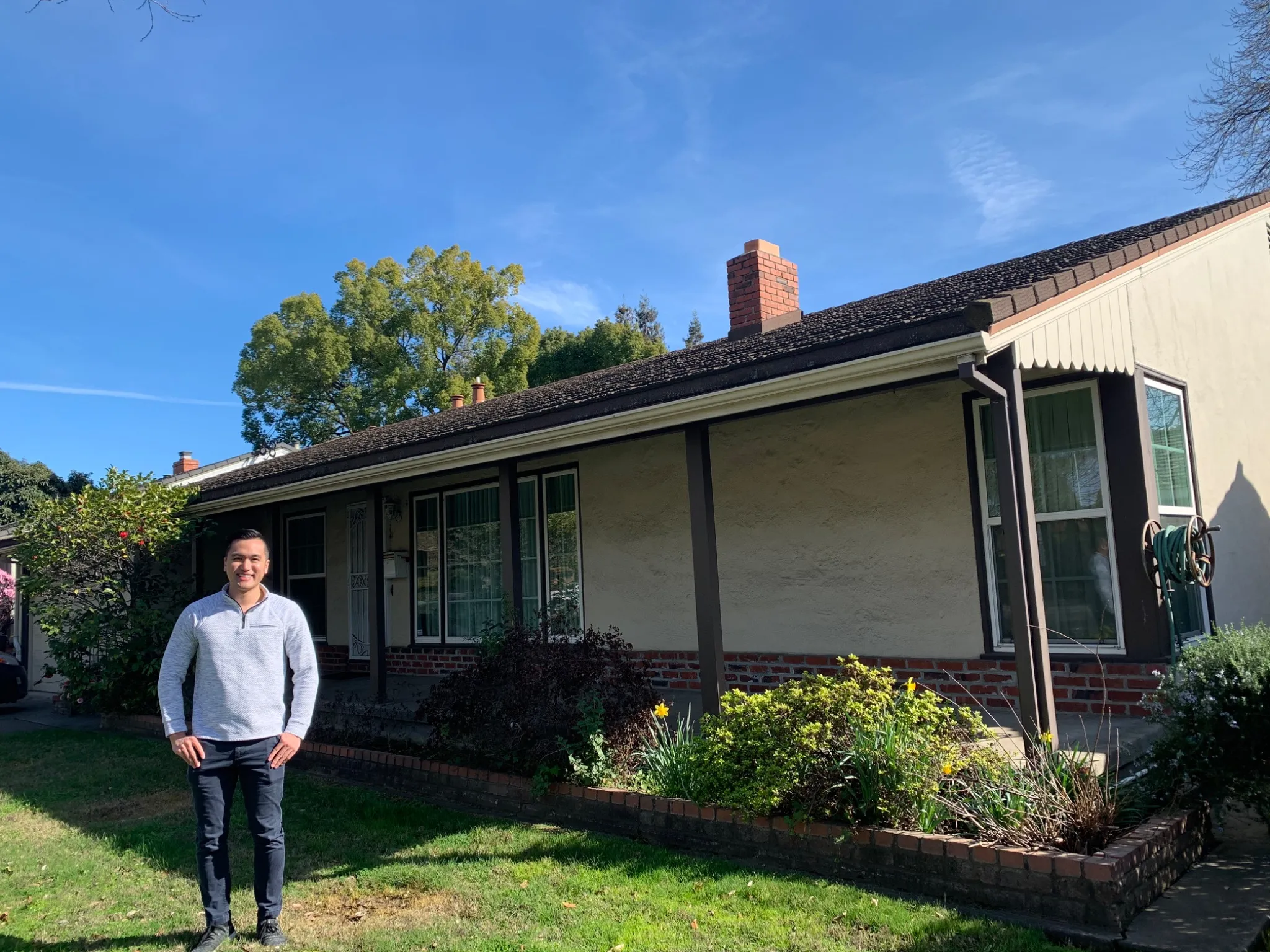 Ryan Chaw in front of an investment property